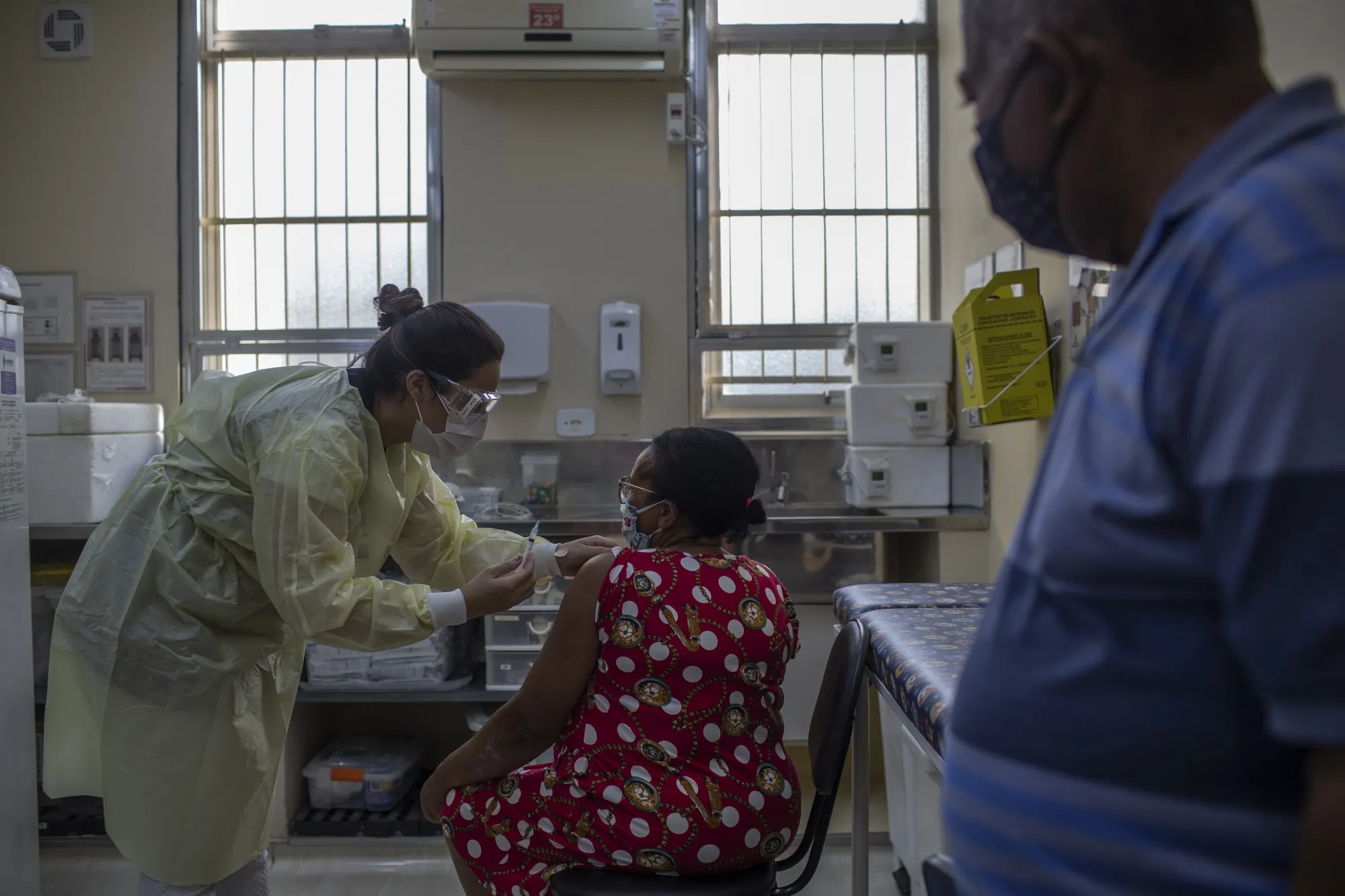 A healthcare worker administers the Sinovac Covid-19 vaccine in the Jardim Mitsutani favela of Sao Paulo, Brazil, on March 15.