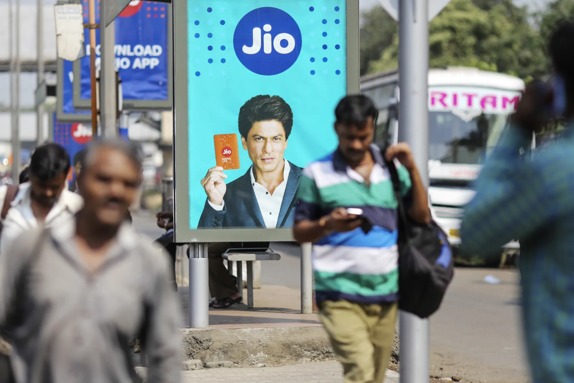 An advertisement for Reliance Jio, featuring Bollywood actor Shah Rukh Khan is displayed at a bus stop in Mumbai, India, on Oct. 24, 2016.