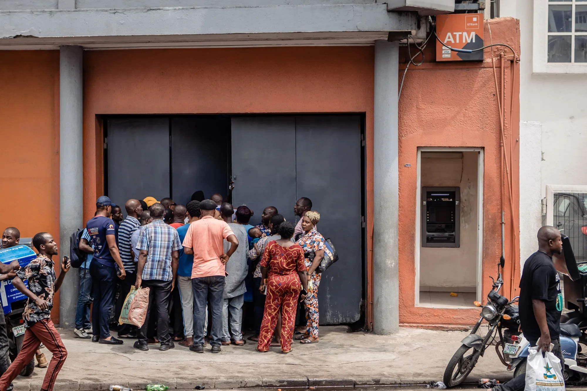 People waiting in line at a bank to withdraw naira banknotes&nbsp;on February 23 in Lagos, Nigeria.