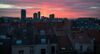 The evening sun sets above the rooftops of residential and commercial buildings in the Northern Quarter business district of Brussels, Belgium.