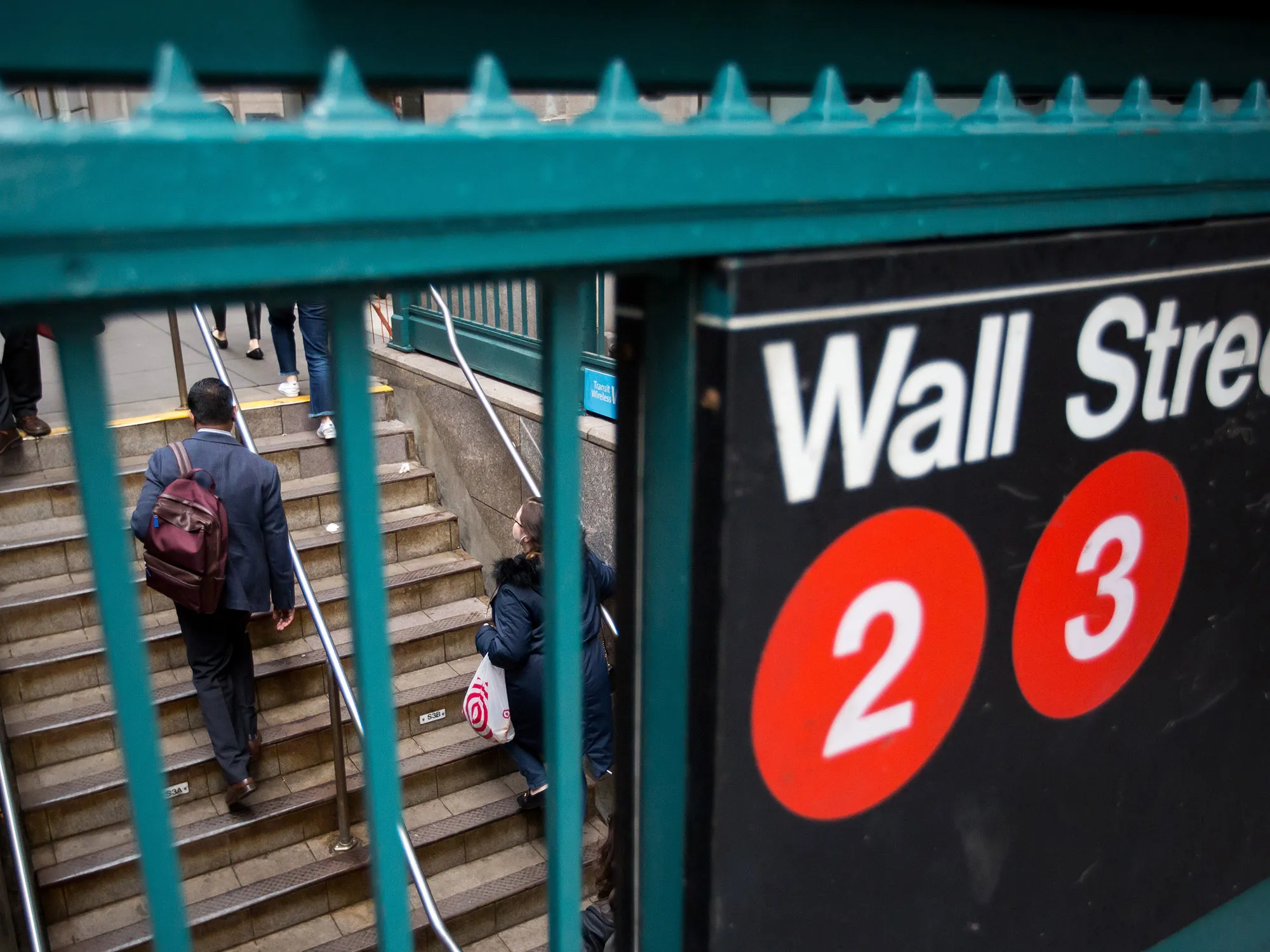 Commuters exit the Wall Street subway station near the New York Stock Exchange (NYSE) in New York.
