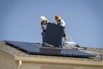 Contractors install SunRun Inc. solar panels on the roof of a new home in Sacramento, California.