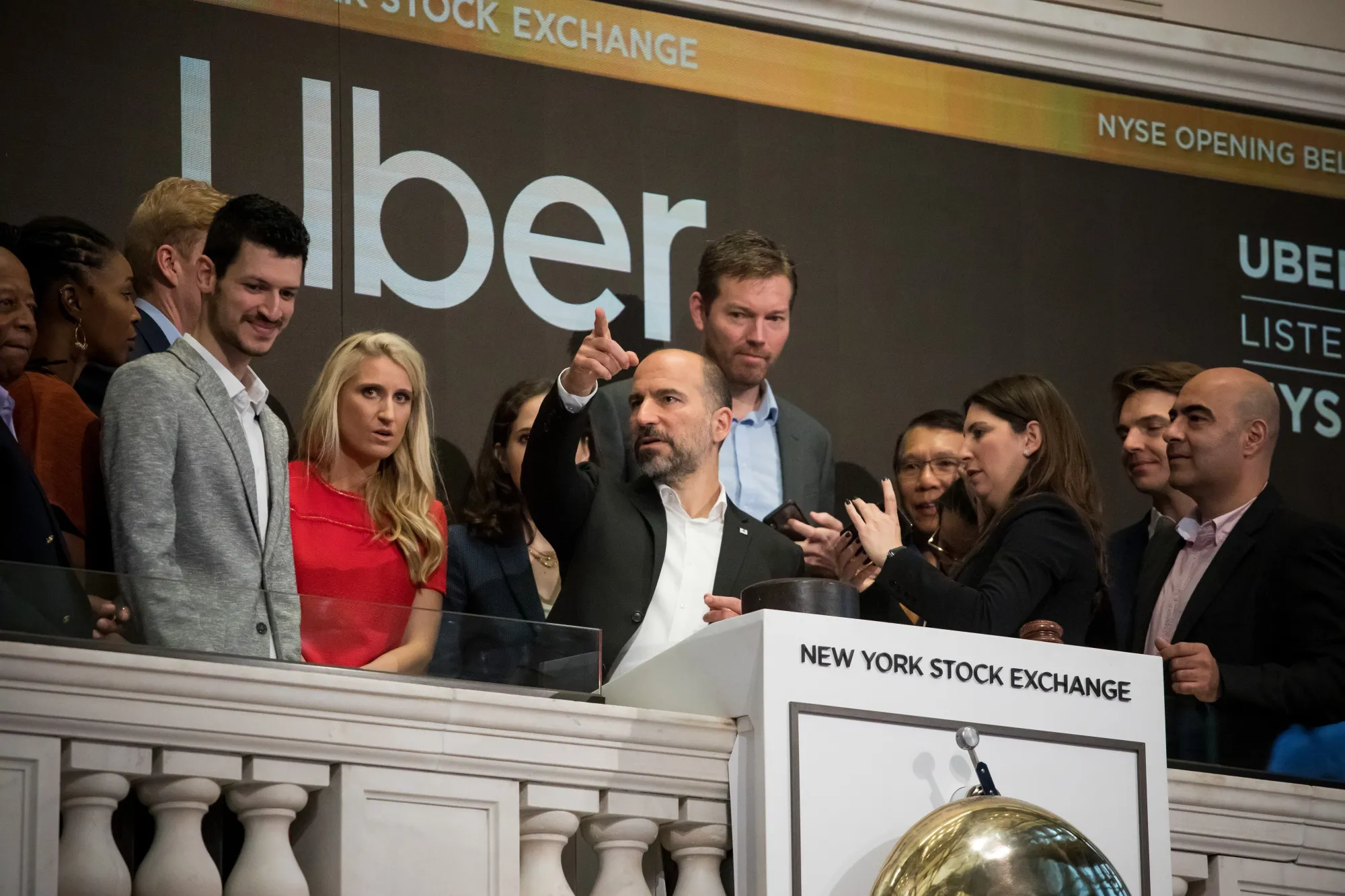 Dara Khosrowshahi, chief executive officer of Uber Inc., center, rings the opening bell during the company's IPO&nbsp;on the floor of the New York Stock Exchange&nbsp;on Friday, May 10, 2019.