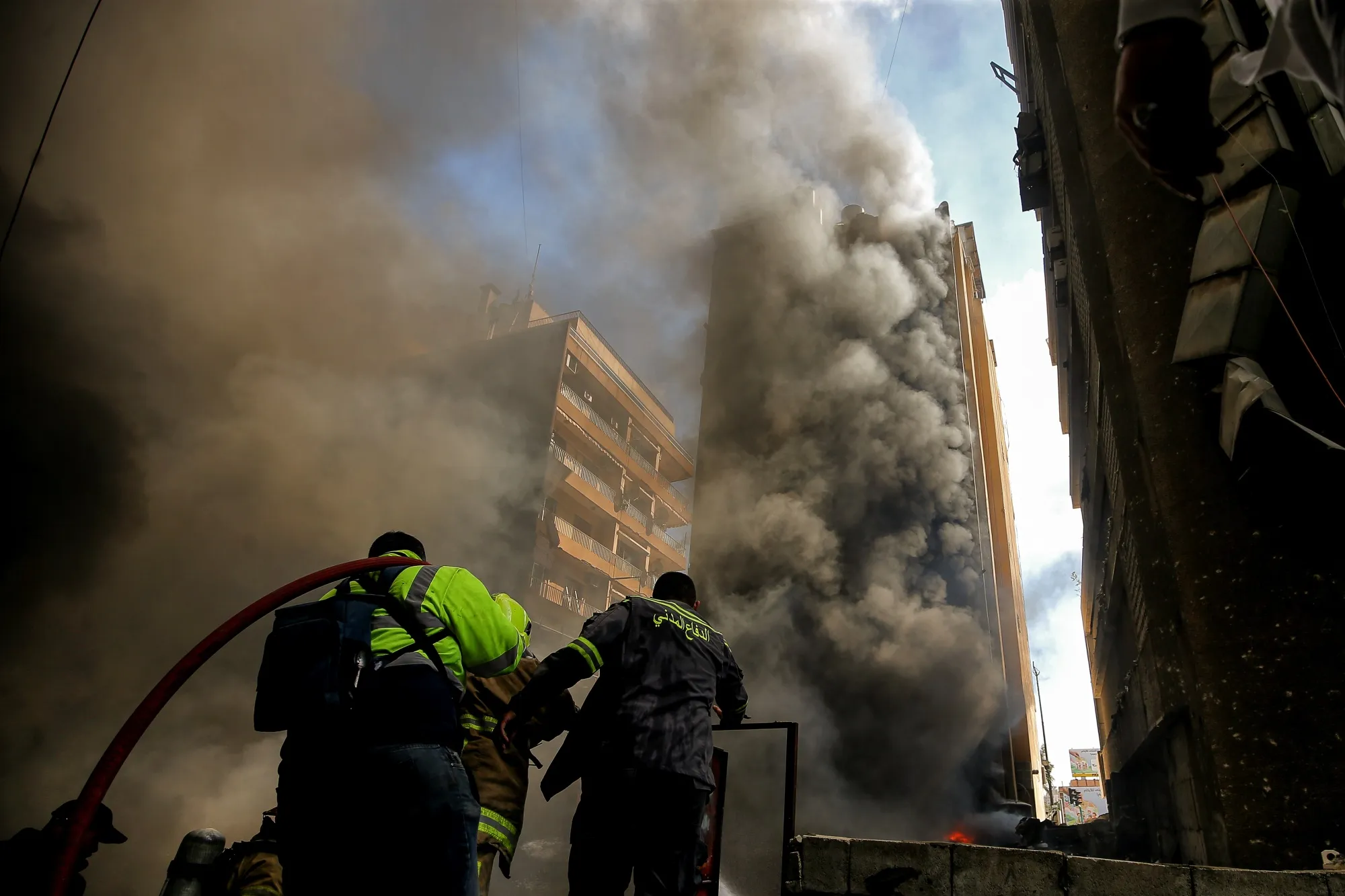 Firefighters battle a fire&nbsp;at a site hit by an airstrike in Beirut on April 8.