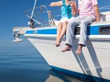 Happy Senior Couple on the Bow of a Sail Boat