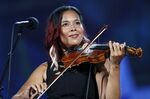 Rhiannon Giddens performs during rehearsal for the Boston Pops Fireworks Spectacular in Boston, on July 3, 2018. Giddens will participate in an online fundraiser for the environment that will be shown on YouTube. The organization Playing for Change is putting on the event in collaboration with the United Nations Population Fund. (AP Photo/Michael Dwyer, File)