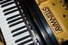 A Steinway & Sons logo appears above the keyboard of a grand piano inside the Steinway & Sons piano factory in the Astoria neighborhood of Queens, New York, U.S., on Tuesday, July 14, 2009. Steinway & Sons, founded in 1853 by Henry Steinway in New York, operates manufacturing facilities in Queens and Hamburg, Germany.
