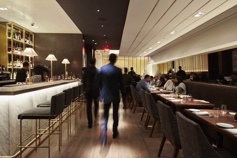 The bar area at Indian Accent, with the dining room in the back.