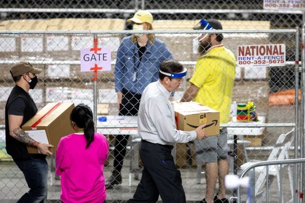 Former Arizona Secretary of State Ken Bennett carrying a box of ballots