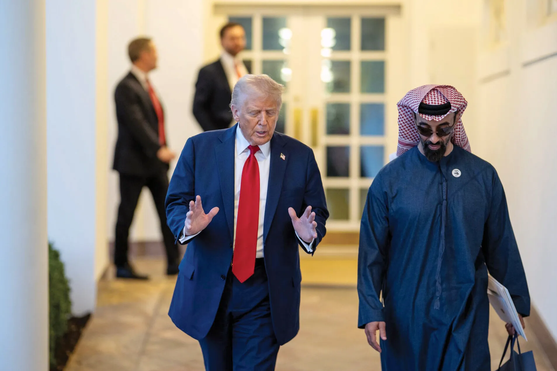 Sheikh Tahnoon bin Zayed Al Nahyan walks next to Donald Trump.
