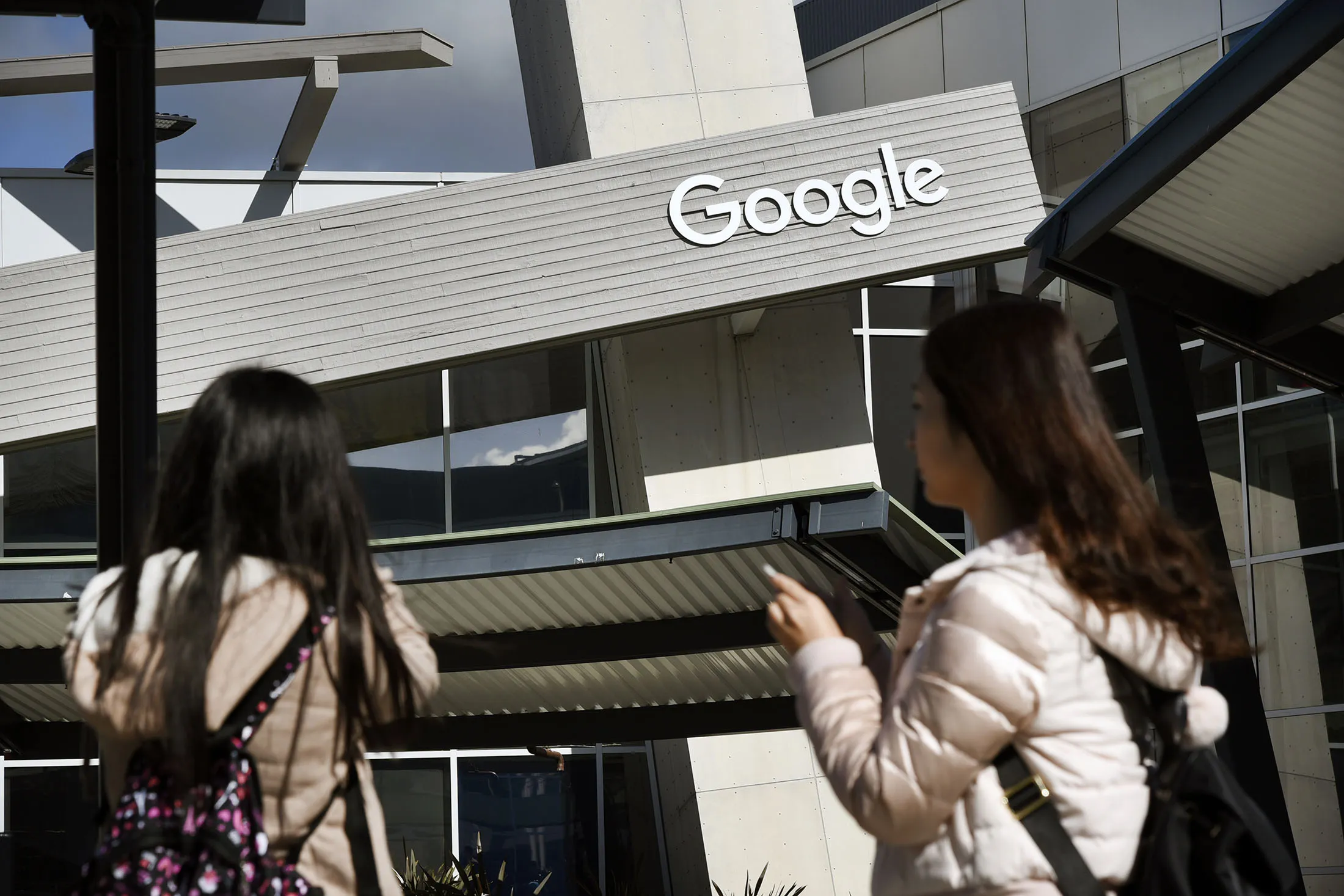 People take pictures of a Google Inc. office building inside the Googleplex headquarters in Mountain View, California.