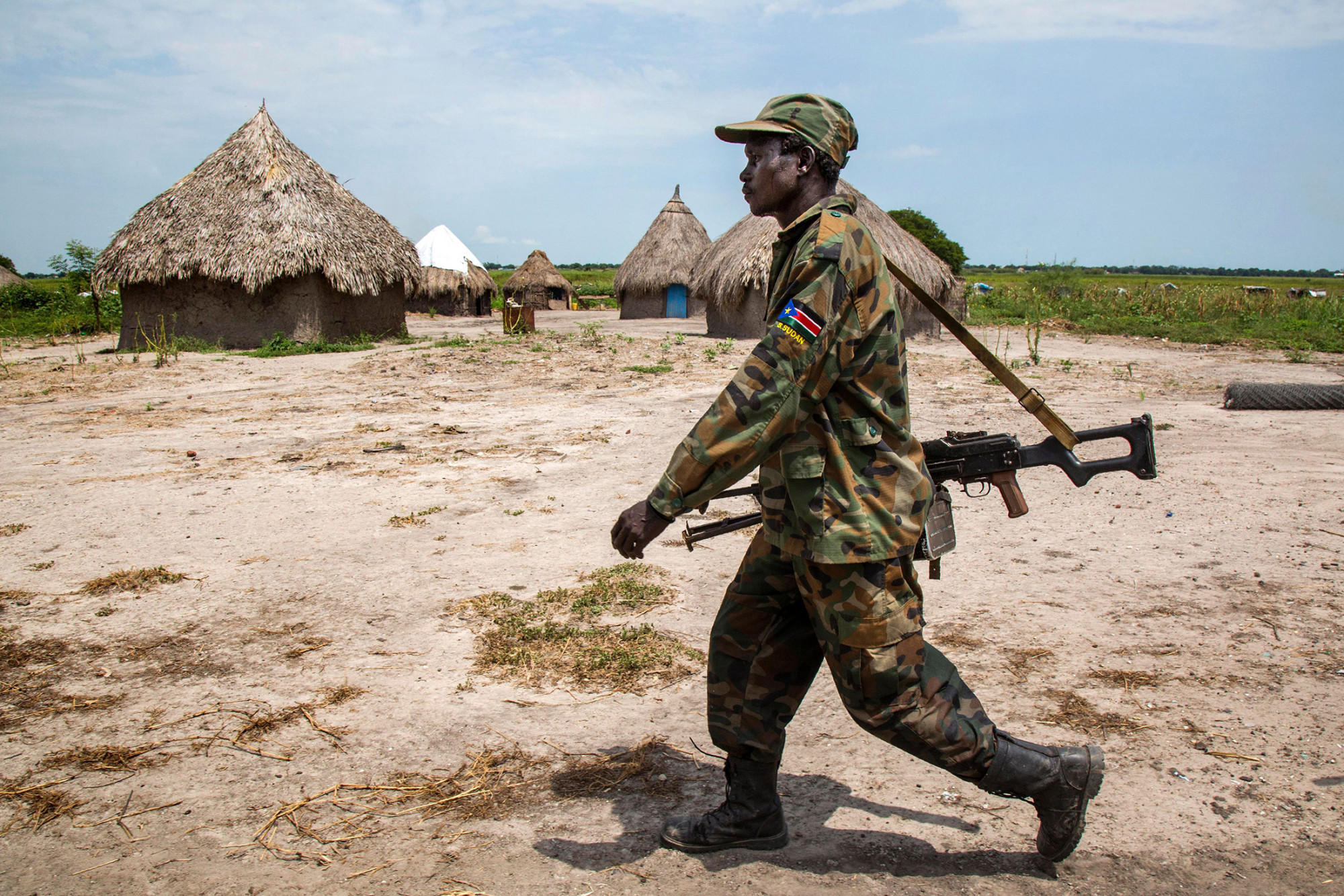 A soldier walks through the empty village of Lelo, outside Malakal, northern South Sudan, on Oct. 16, 2016.
