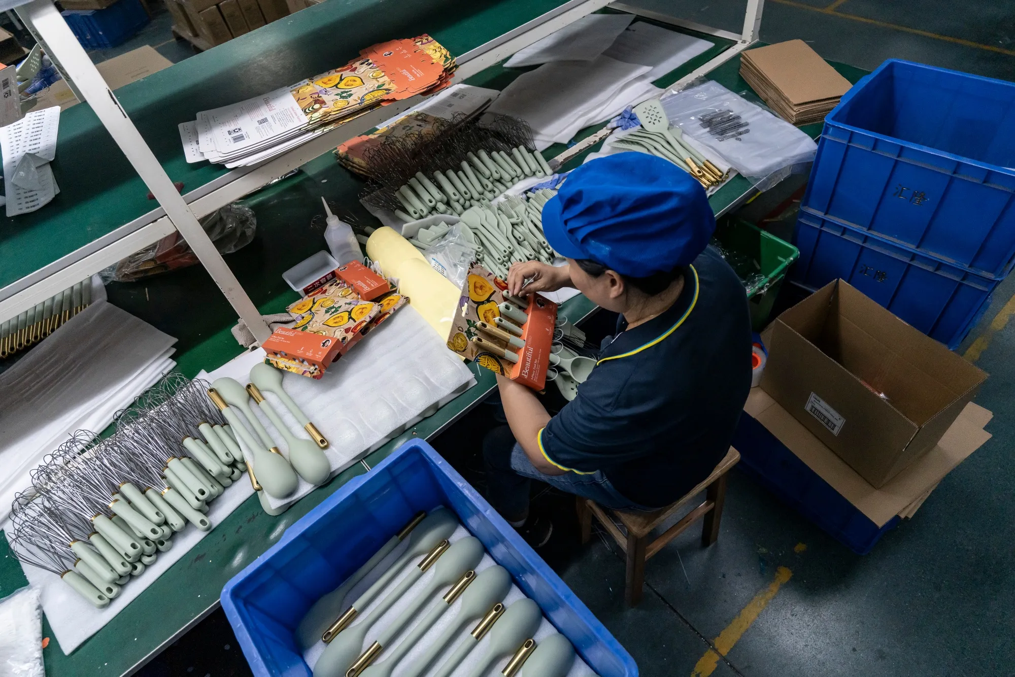 A worker on the production line for kitchen utensils at a factory near Zhuhai, China.