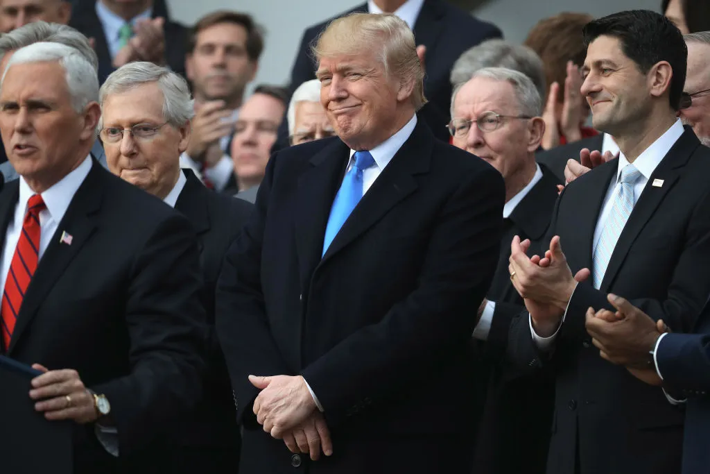 President Donald Trump, flanked by Republican lawmakers, celebrates Congress passing the Tax Cuts and Jobs Act on the South Lawn of the White House on December 20, 2017 in Washington, DC.