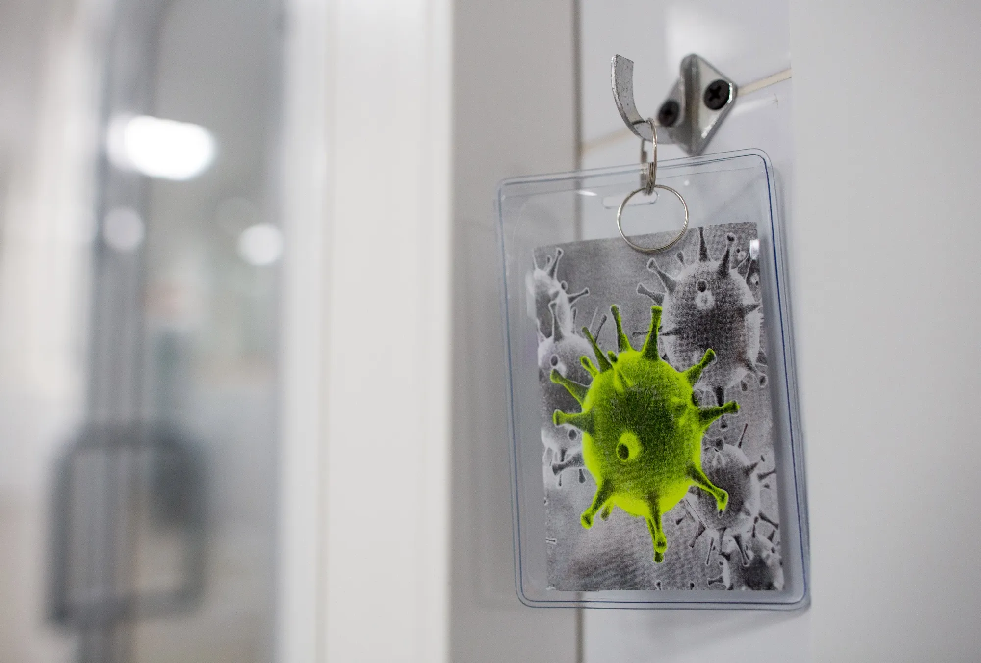 A keyring displaying an image of coronavirus.