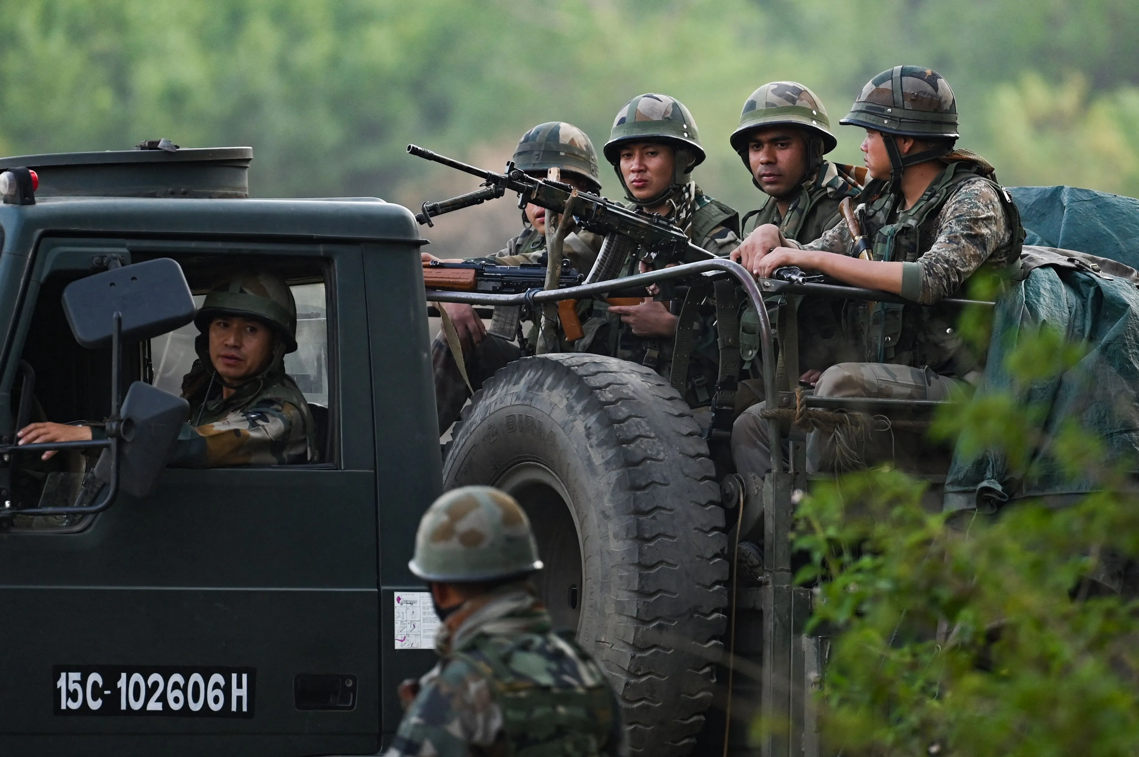 Indian Army servicemen patrol during a rescue operation following ethnic violence in the region, near Imphal, India, on May 7.
