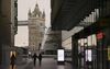 Pedestrians walk towards Tower Bridge in London, U.K.