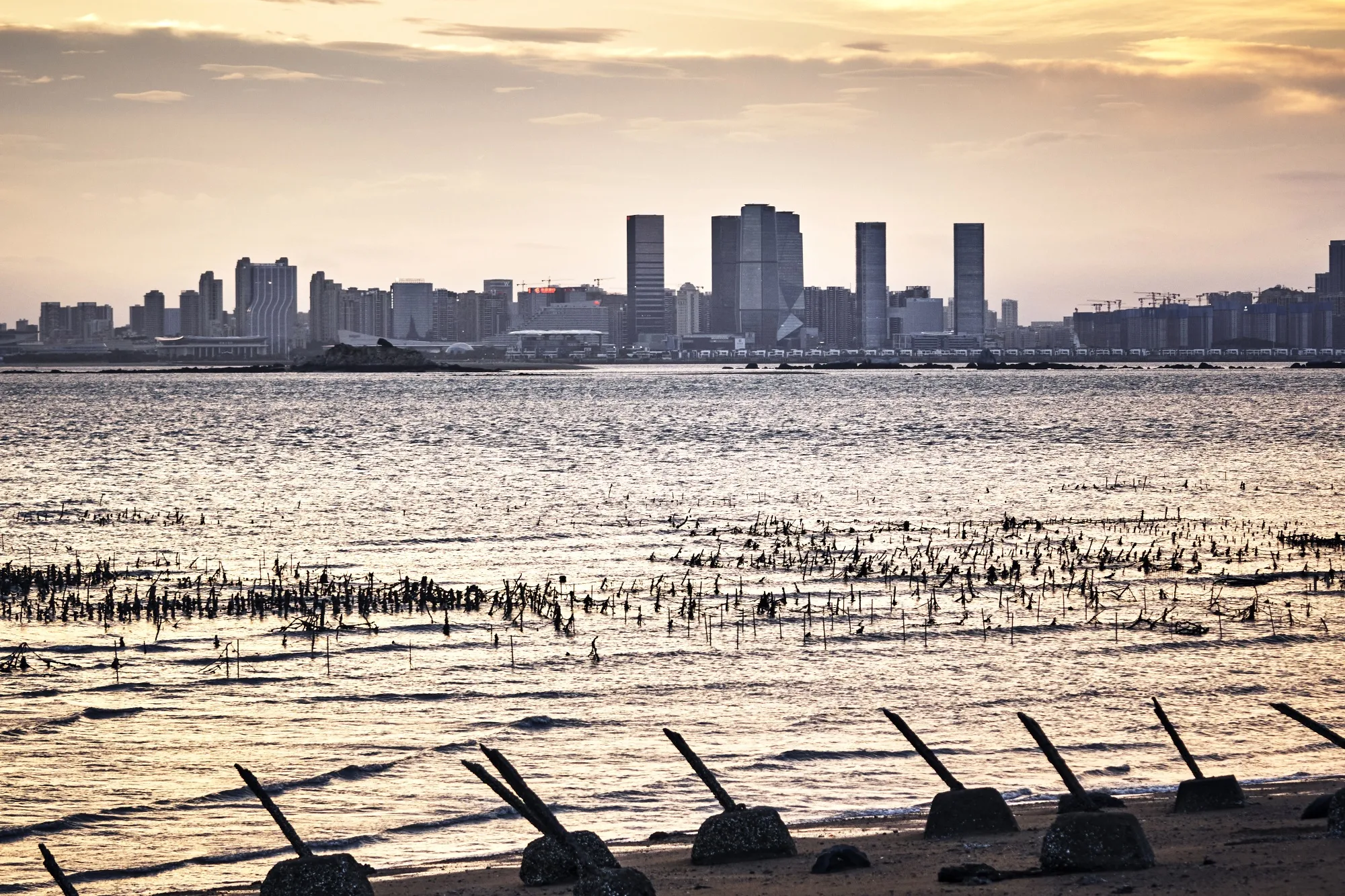 Buildings in Xiamen, across the Taiwan Strait from anti-landing barriers on a beach in Kinmen, one of Taiwan’s outlying islands.