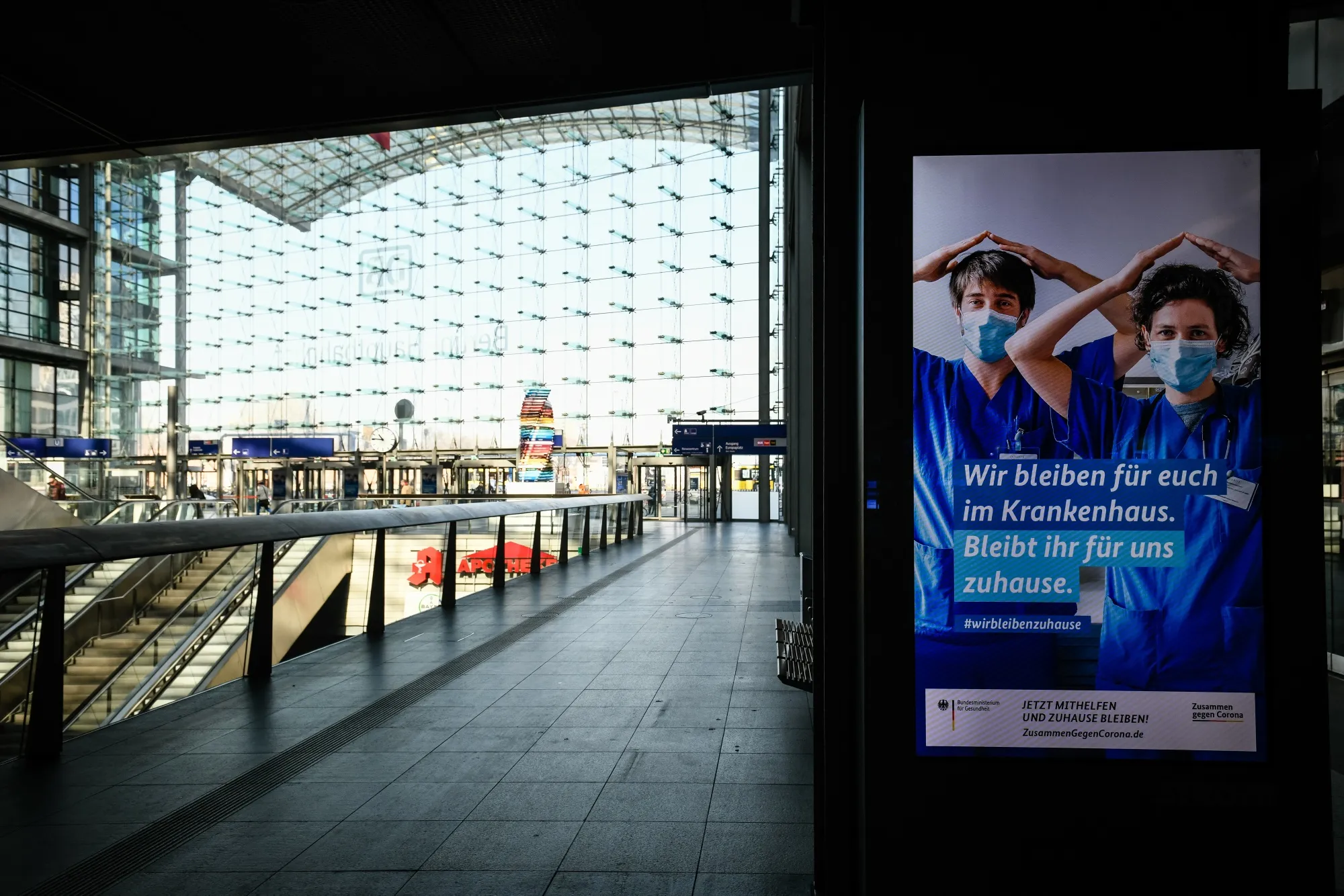 A public information screen&nbsp;advises people to 'stay at home' to avoid spreading the coronavirus, at Berlin's main train station on March 26.