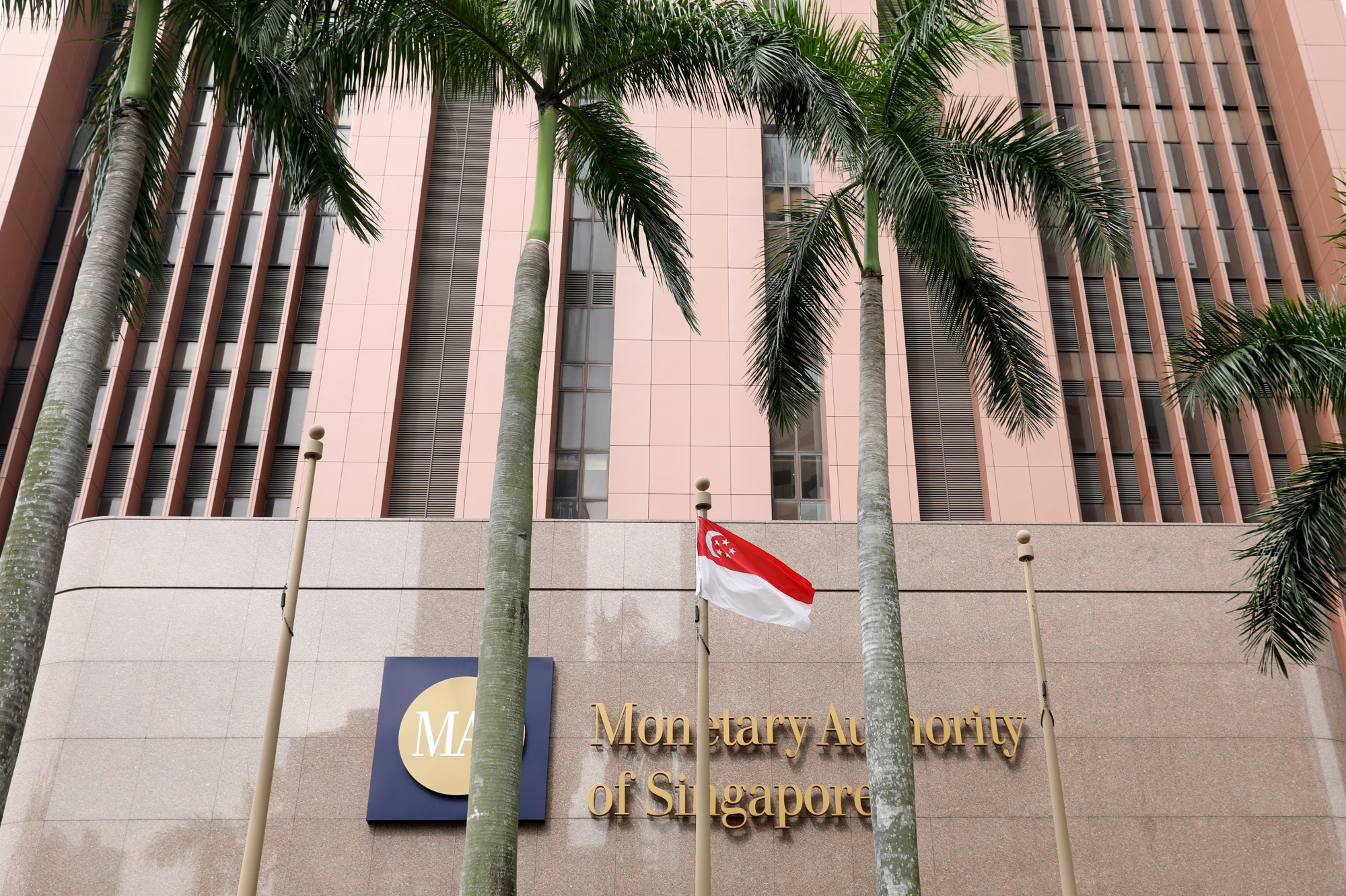 A Singaporean flag flies in front of the Monetary Authority of Singapore&nbsp;headquarters in Singapore.
