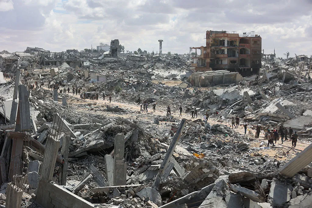 Palestinians search the rubble of buildings amid widespread destruction&nbsp;in Khan Yunis in the southern Gaza Strip on Oct. 12.