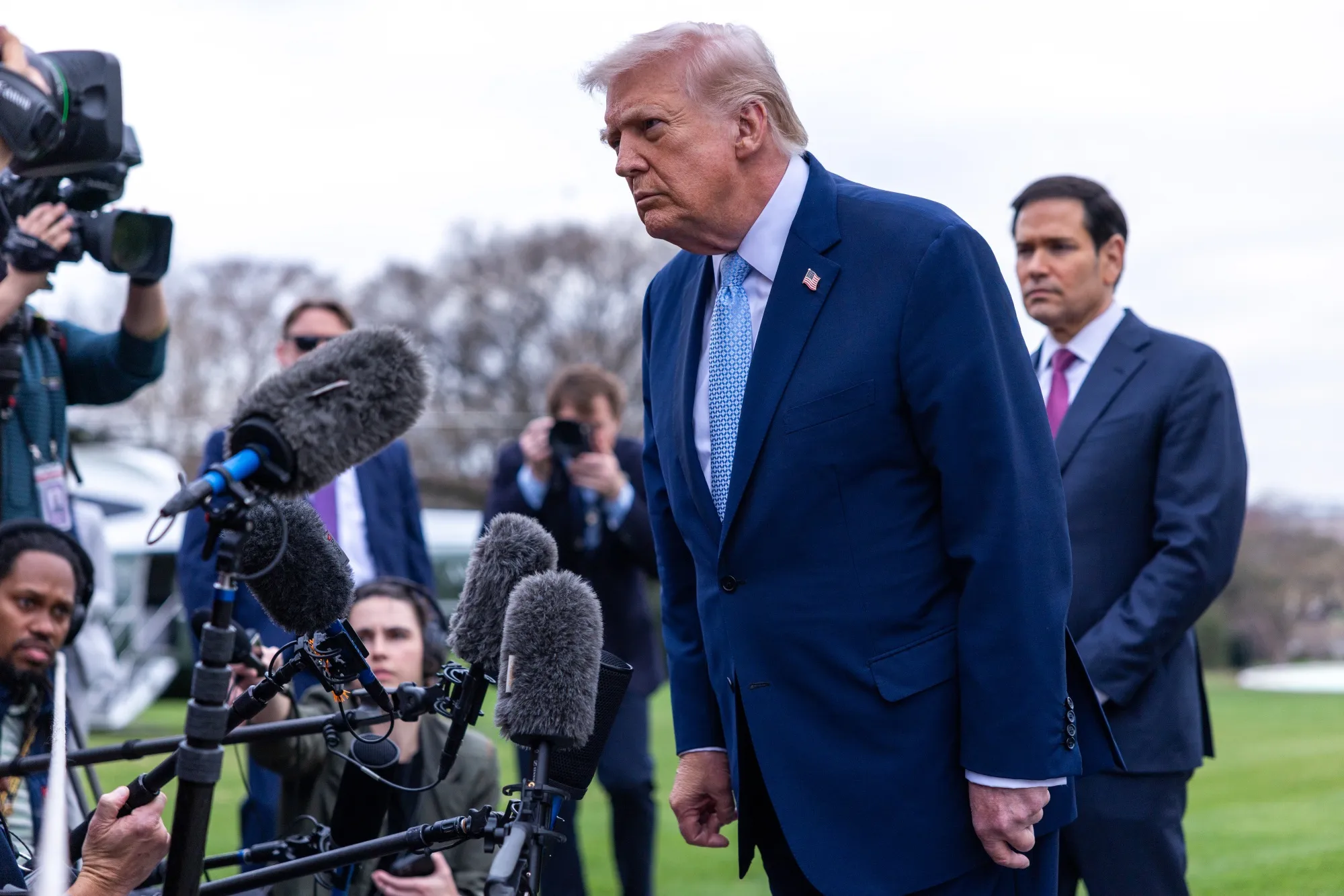 US President Donald Trump with&nbsp;members of the media on the South Lawn of the White House on March 20.&nbsp;