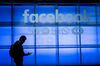 An attendee looks at a mobile phone while walking the demonstration room during the F8 Developers Conference in San Jose, California, U.S., on Tuesday, April 30, 2019. Facebook Inc. unveiled a redesign that focuses on the Groups feature of its main social network, doubling down on a successful but controversial part of its namesake app and another sign that Facebook is moving toward more private, intimate communication.