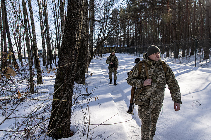 The Ukrainian Border Guard patrol along the Ukrainian border fence at a border crossing between&nbsp;Ukraine, Russia and Belarus, in Senkivka, Ukraine, on Feb. 14.