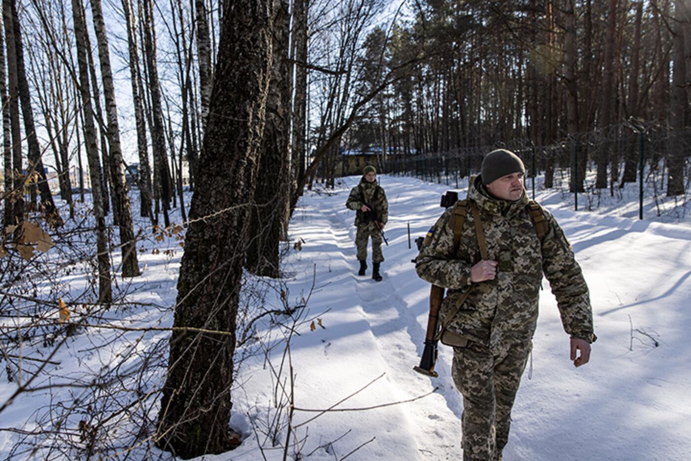 The Ukrainian Border Guard patrol along the Ukrainian border fence at a border crossing between Ukraine, Russia and Belarus, in Senkivka, Ukraine, on Feb. 14.