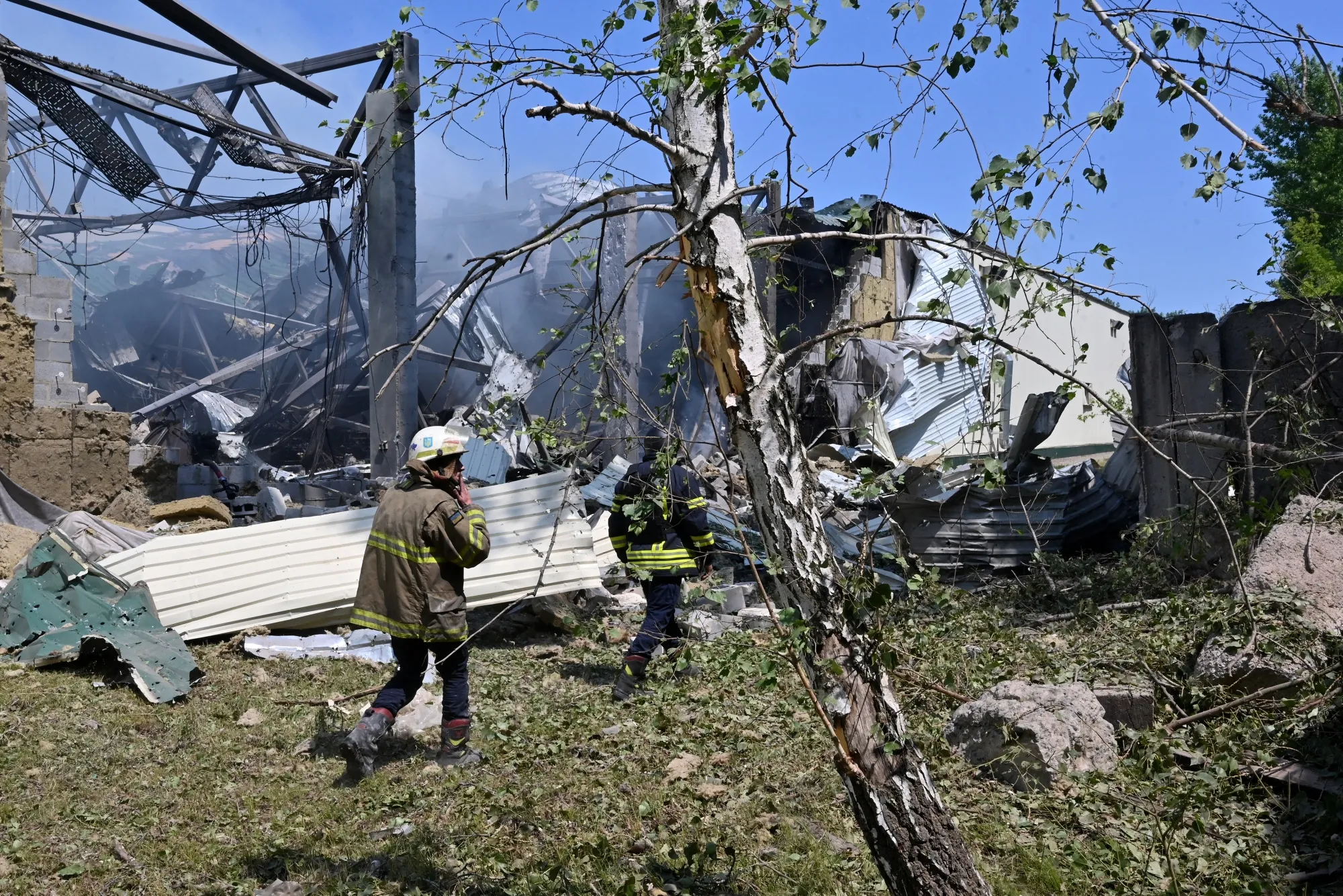 Ukrainian rescuers work at the site of a missile attack in Kharkiv on May 23.