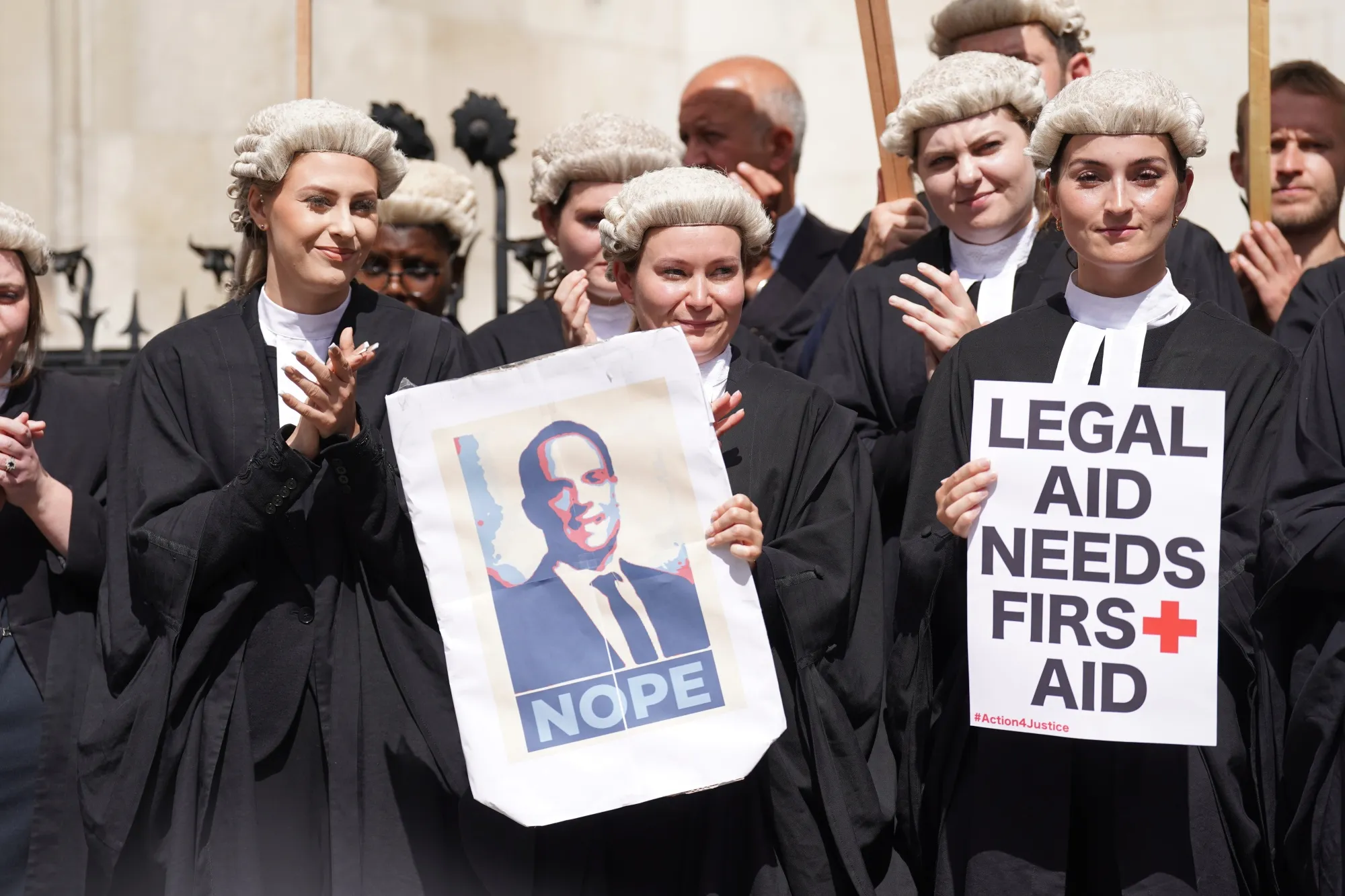 Criminal defence barristers gather outside the Royal Courts of Justice in London on Monday, July 4.