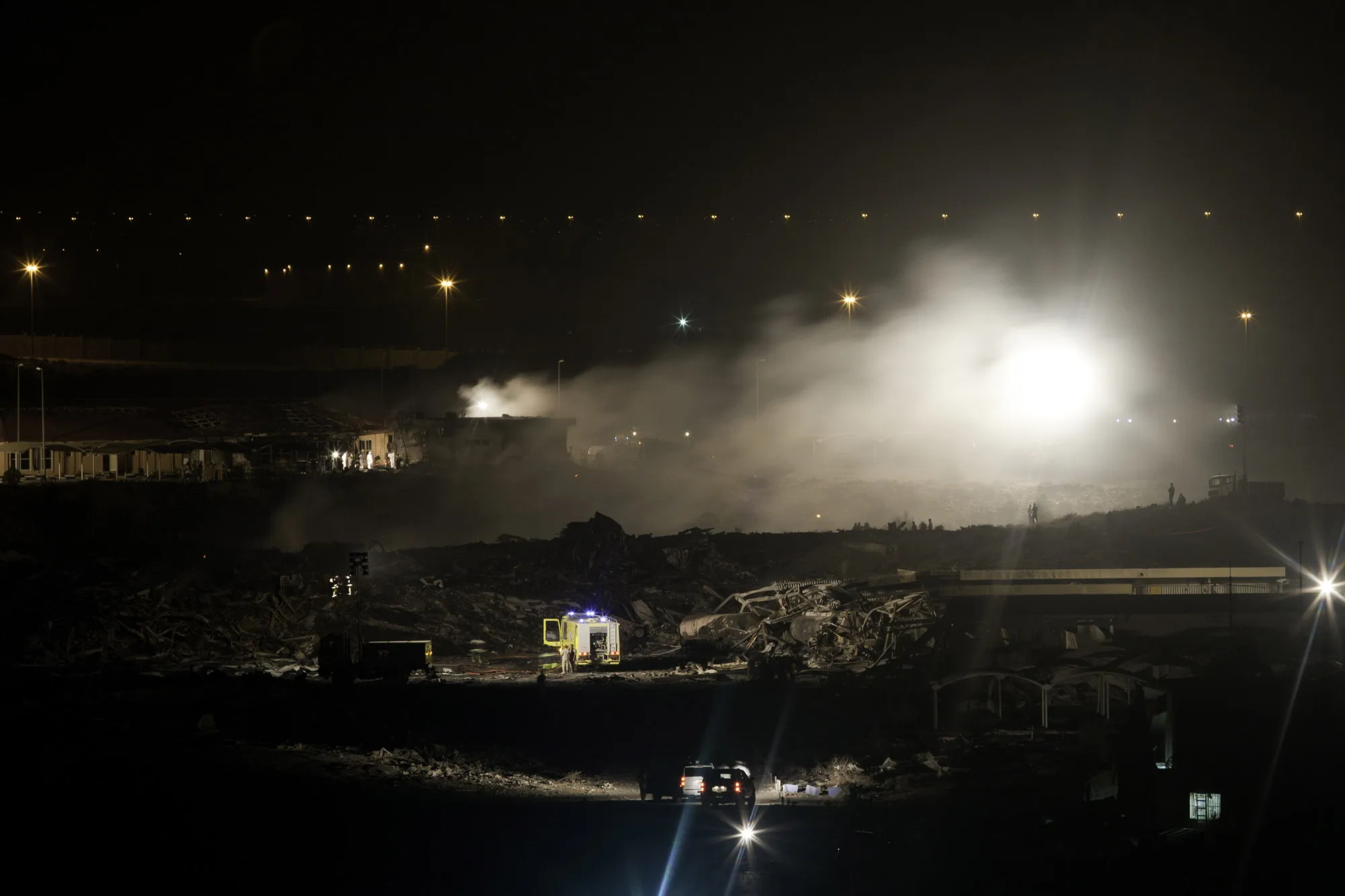 Workers at the site of a crashed UPS plane near Dubai International Airport on Sept. 3, 2010.