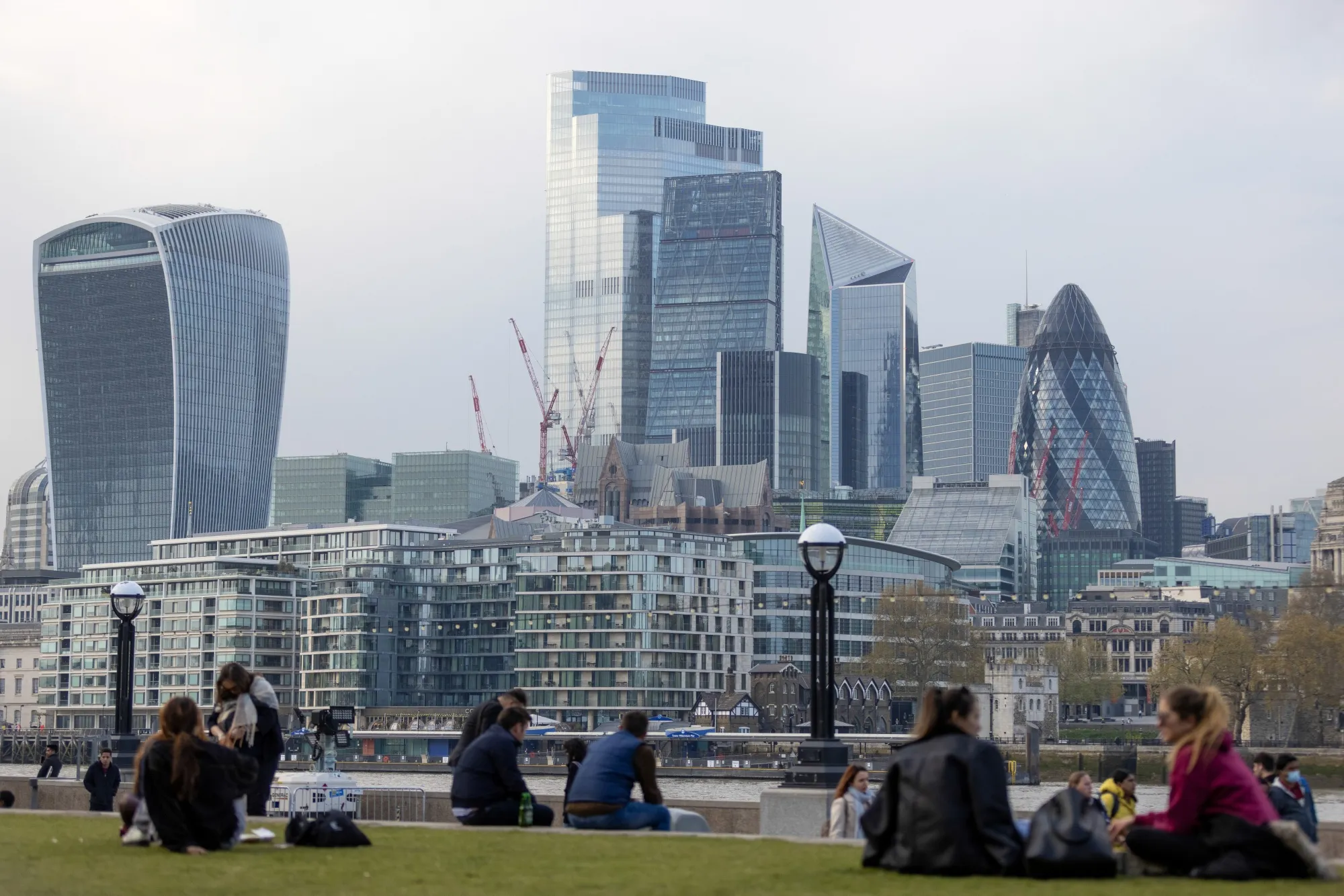 Cranes have become a familiar sight&nbsp;around 30 St. Mary Axe, also known as The Gherkin, as people take in the skyline on April 27, 2021.