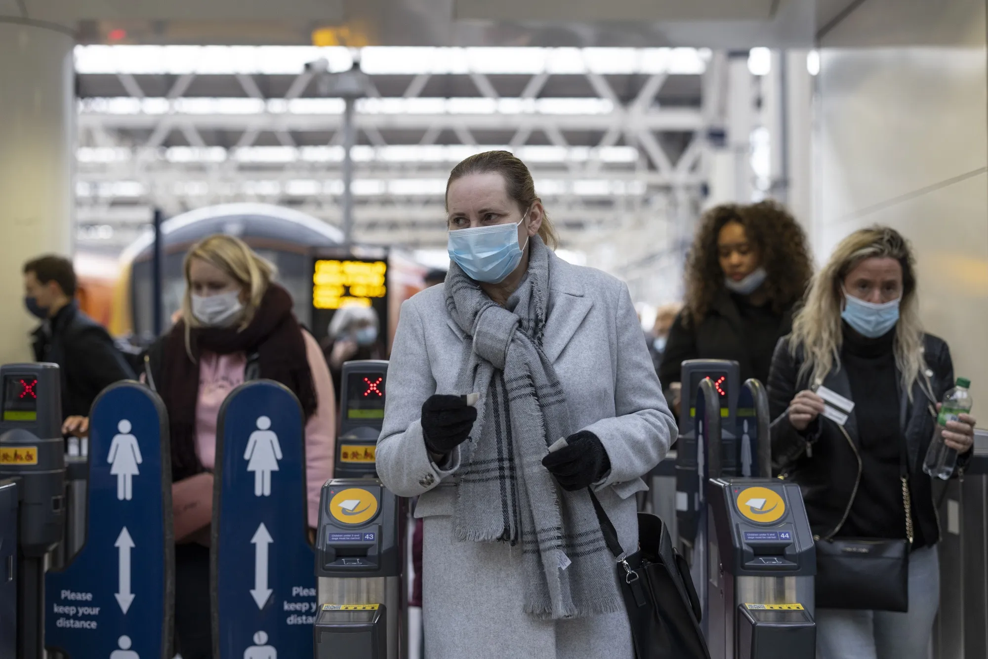 City commuters wear face masks&nbsp;at Waterloo station in London.&nbsp;