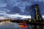 A sightseeing boat travels on the River Main past the European Central Bank (ECB) skyscraper headquarters.