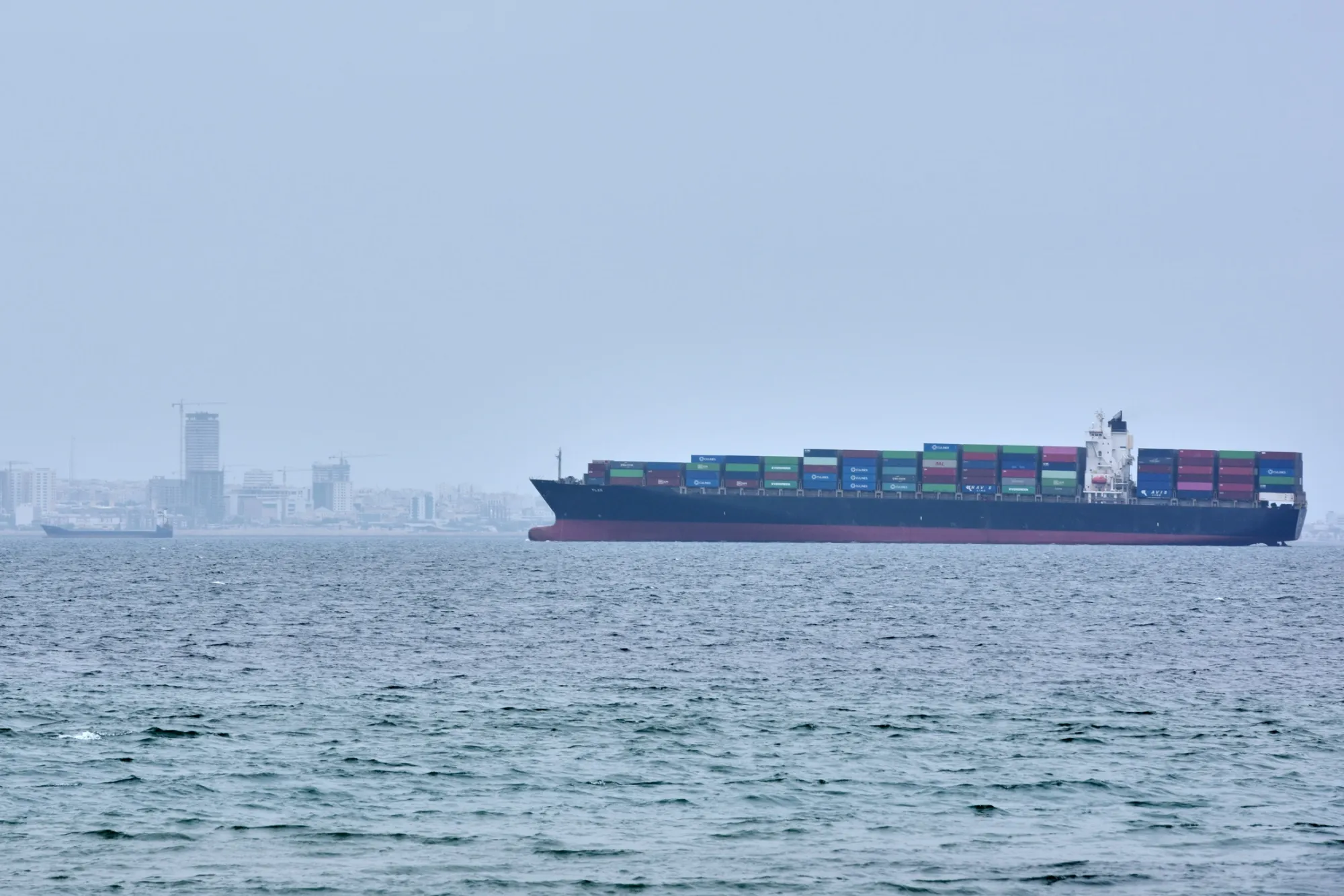 A container ship in the Strait of Hormuz off the coast of Qeshm Island, Iran, on April 18. After two months, there is still no resolution to the US-Israel war with Iran in sight.