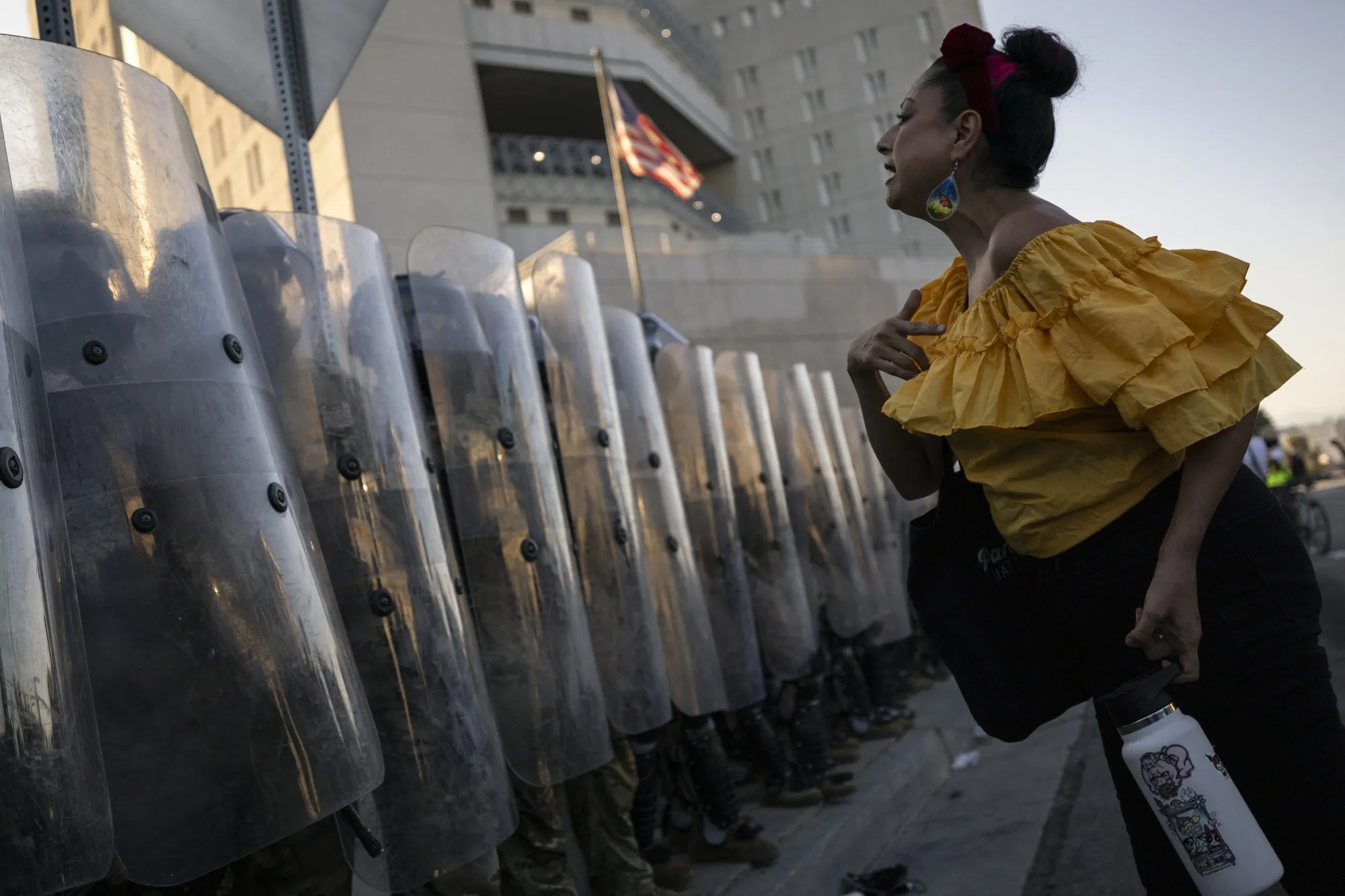 A demonstrator interacts with US marines and national guards protecting the entrance of the Metropolitan Detention Center in Los Angeles on July 4.