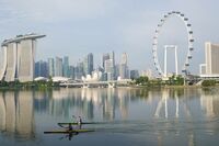 Kayakers row past the central business district at Marina Bay in Singapore in October. 