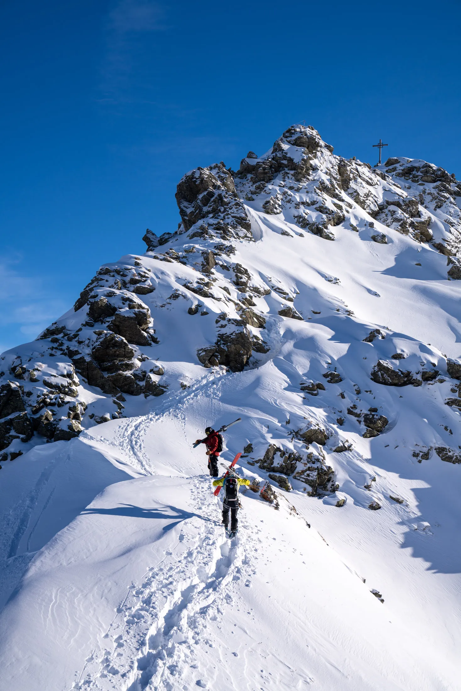 The author and the group’s guide, Hannes Schneider,&nbsp;climbing to Muttjöchle, one of the peaks at Kristberg. Schneider is carrying the photographer’s skis so she can capture this photo.