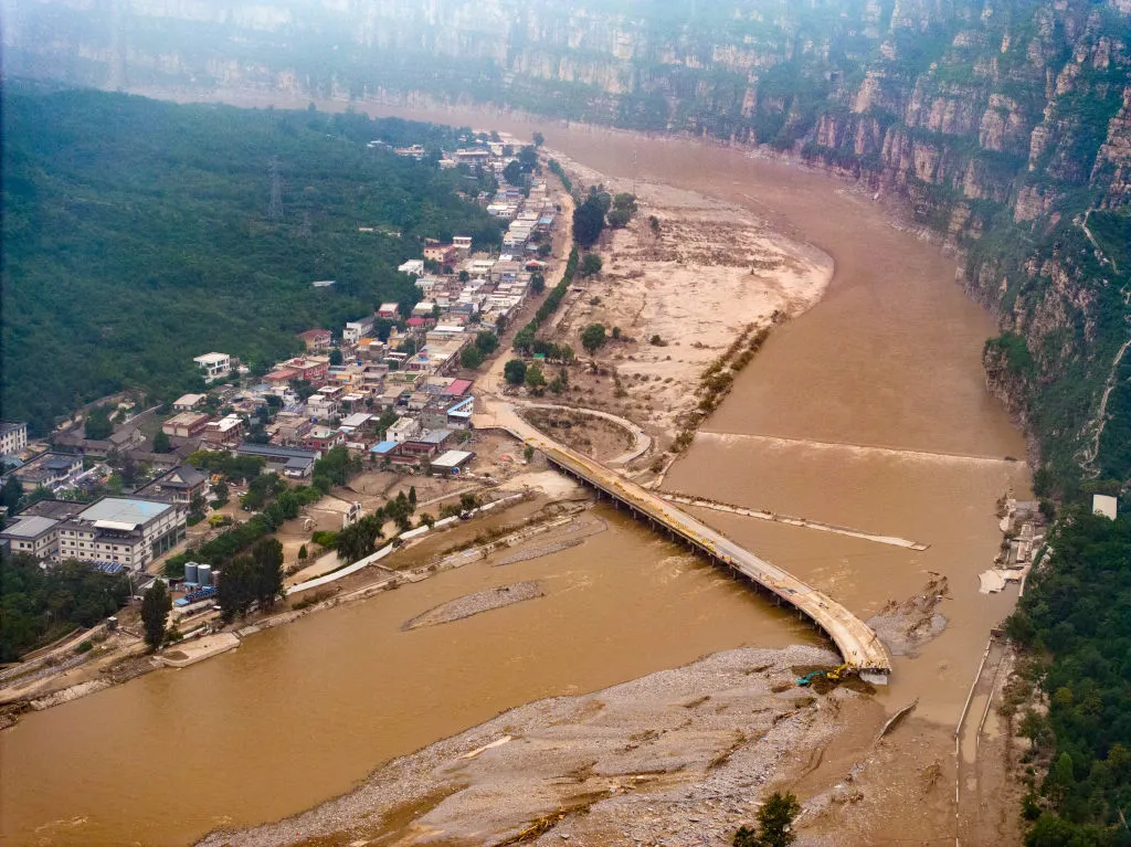 Excavators operating to repair the collapsed roads in flood-hit areas in Fangshan District of&nbsp;Beijing, Aug 4.&nbsp;