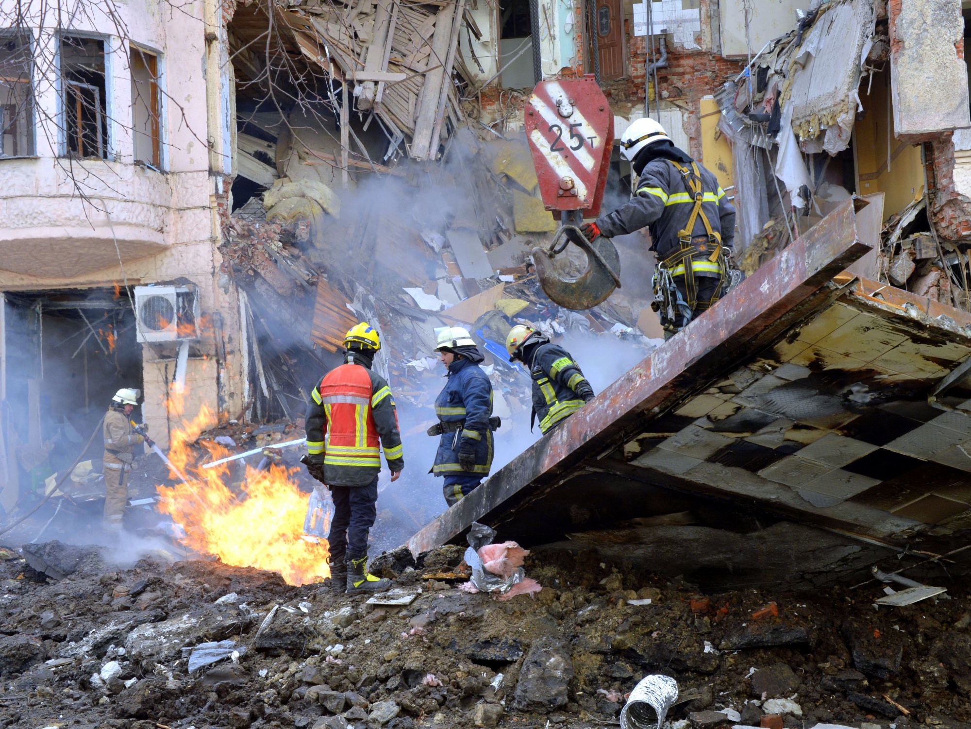 Firemen work to clear the rubble in Kharkiv on March 14.&nbsp;