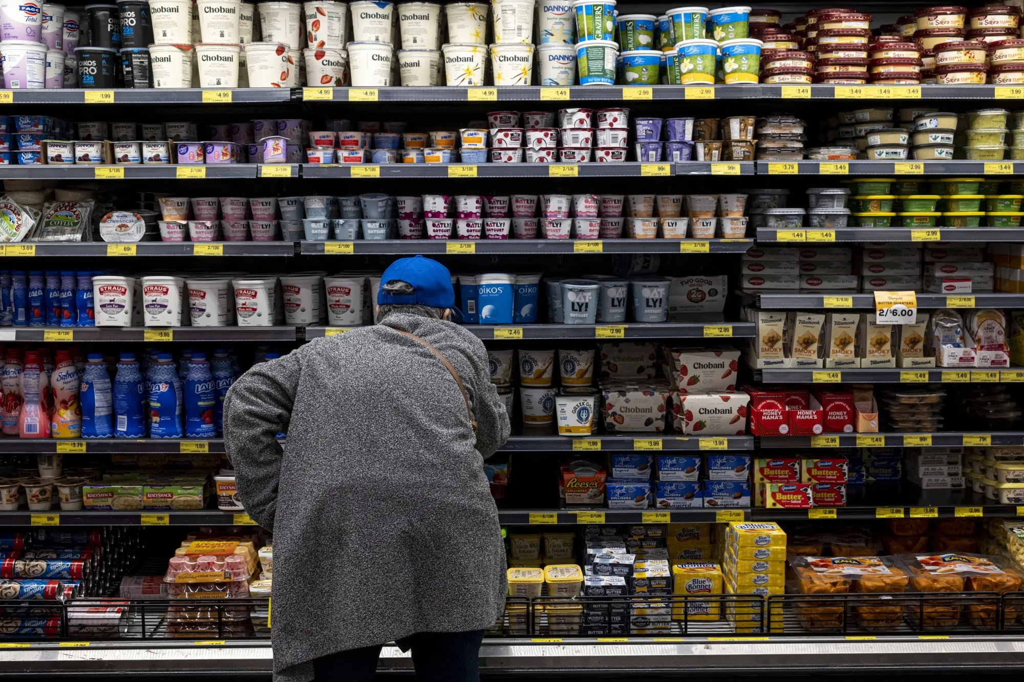 A customer checks the prices of dairy products at a&nbsp;grocery store in San Francisco.