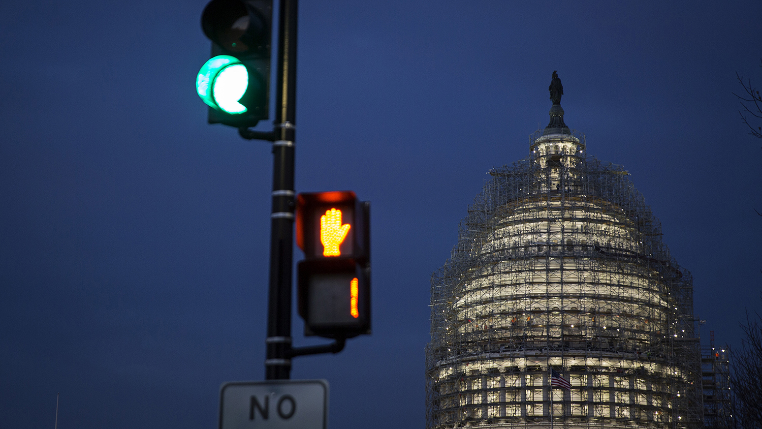The illuminated dome of the U.S. Capitol building is seen behind a traffic light in Washington on Dec. 11, 2015.
