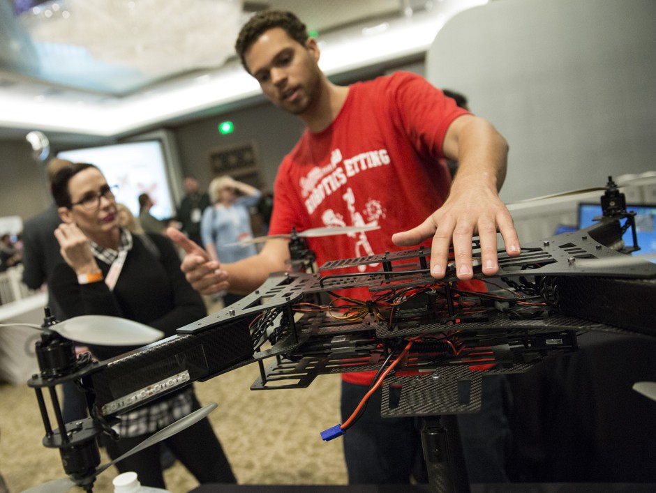A man explains the workings of a robotic drone at the South by Southwest (SXSW) conference in Austin, Texas. The city's tech boom put Travis County at the top of Emsi's Talent Attraction Scorecard.