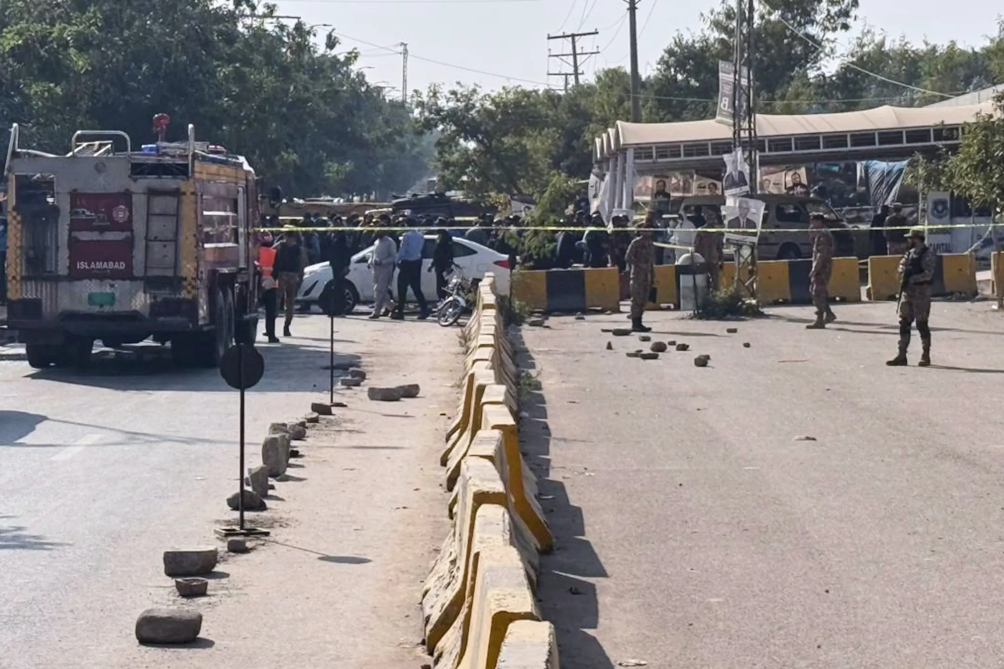 Security personnel stand guard at the site of a car bomb explosion outside a district court in Islamabad, on Nov. 11.