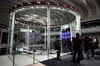 Visitors look at the trading floor at the Tokyo Stock Exchange.