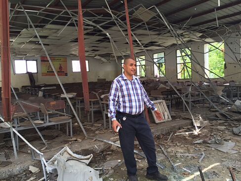 Mohammed Hatem stands in what was the biggest hall of the faculty of arts, at Taiz University, in Taiz, Yemen.