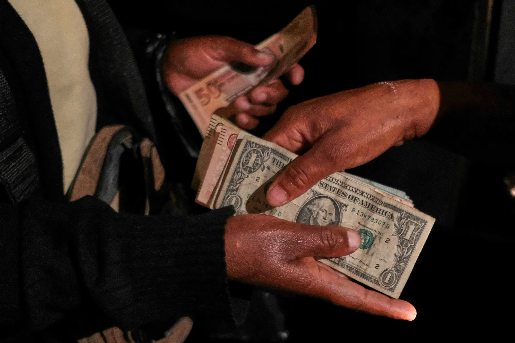 Zimbabwean and US dollars change hands at a bakery in Harare.