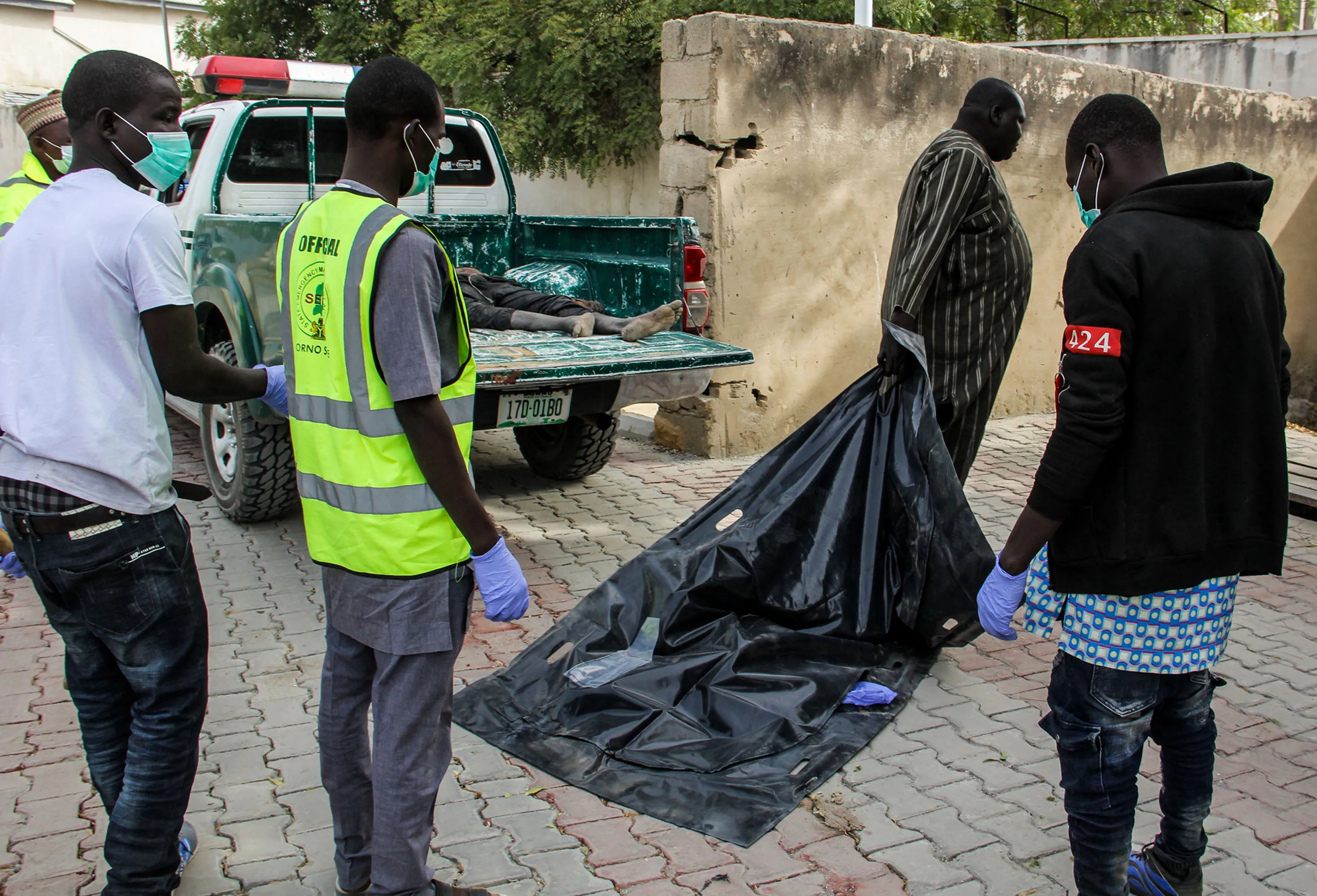 Officials load the body of a victim in Maiduguri, on Feb.16.&nbsp;