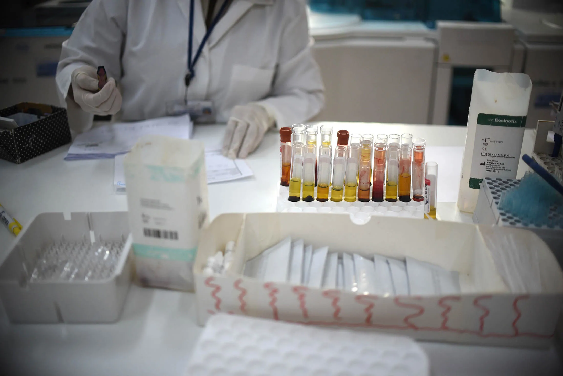 A lab technician analyzes blood samples of pregnant women in Guatemala, Pharmaceutical companies are beginning work toward a vaccine to combat Zika.
